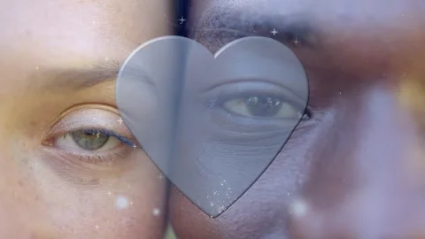 Pair pressing faces, heart overlay appearing between faces, animating sparks, Stockbeeldmateriaal 340674868