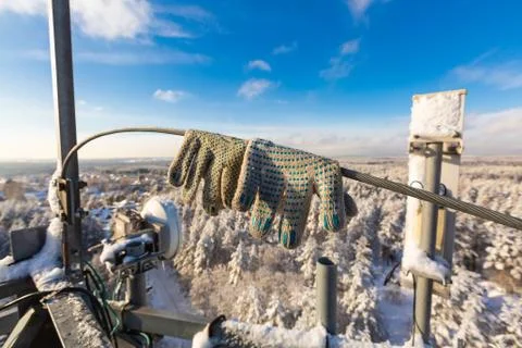Pair of protective gloves of worker-climber is on the top of telecommunication Stock Photos