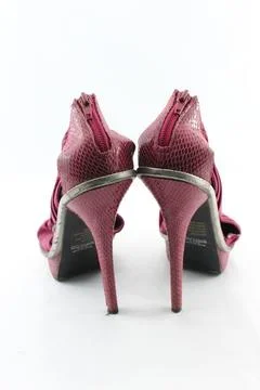 Pair of python leather high-heel shoes isolated on a plain white background. Stockfoto's