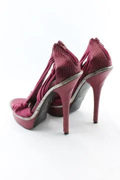 Pair of python leather high-heel shoes isolated on a plain white background. Photos