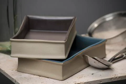 Pair of Rectangular Deep Dish Beside Spoons on Stone Countertop Stock Photos