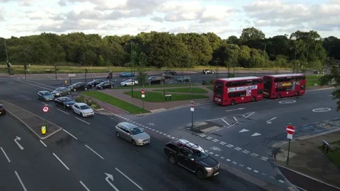Pair of red double deckers waiting at bus stand, road intersection Stock-Footage 164811062