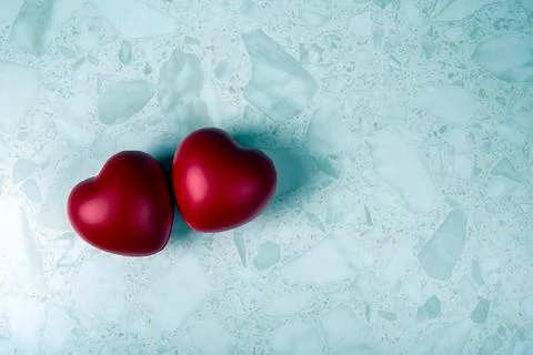 Pair of red hearts on grey background Foto stock