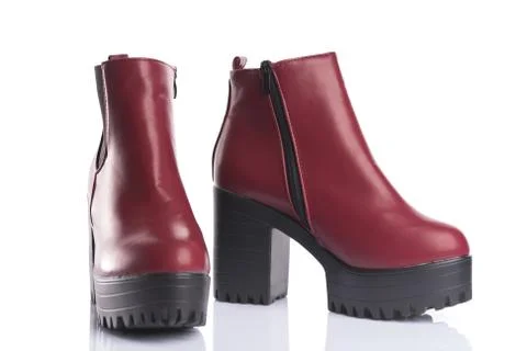 Pair of red platform boots with chunky heels for spring or autumn wear Stock-Fotos
