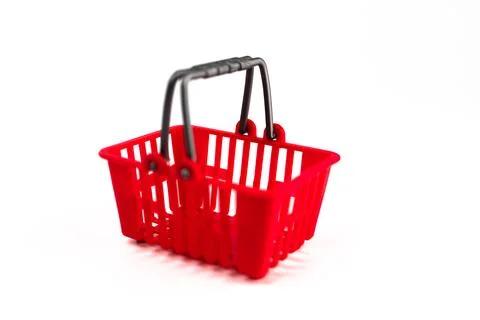 A pair of red shopping baskets, connected by a black handle, positioned sid.. Photos