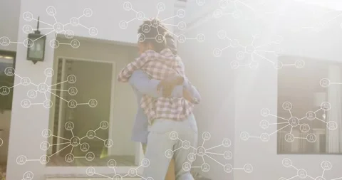 Pair reuniting at entry, man lifting partner rotating toward sun with tech node Video stock 326974945