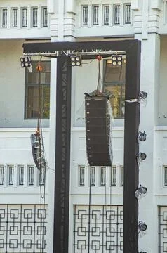 A pair of rigging, lighting, and line array speakers at a concert or large .. Stock Photos
