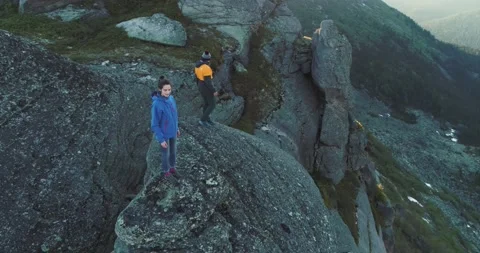 Pair of rock climbers guy and girl climb rock in mountains in summer Stock Footage 199559683