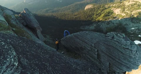 Pair of rock climbers guy and girl climb rock in mountains in summer Stock Footage 199559714