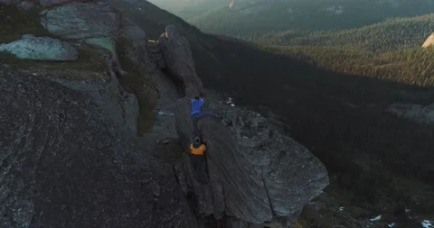 Pair of rock climbers guy and girl climb rock in mountains in summer Stock Footage 199559750