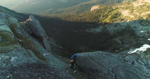 Pair of rock climbers guy and girl climb rock in mountains in summer Stock Footage 199559783