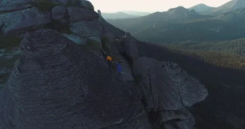 Pair of rock climbers guy and girl climb rock in mountains in summer Stock Footage 199559818