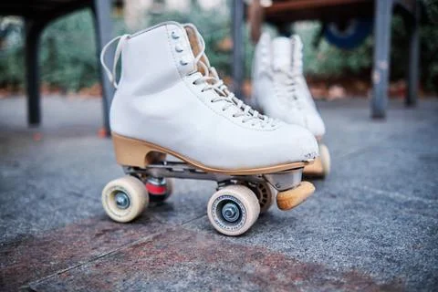 A pair of roller skates on the sidewalk. Stock Photos