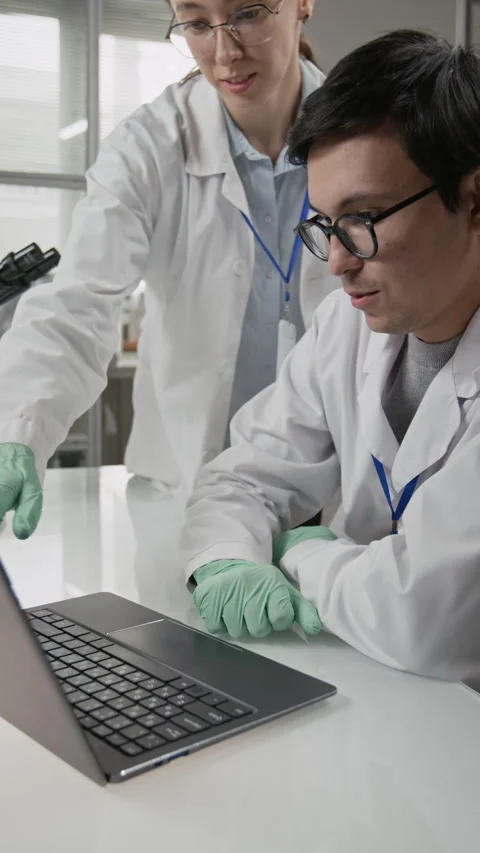Pair of Scientists Reviewing Experimental Findings on Laptop in Lab Stock Footage 321902935