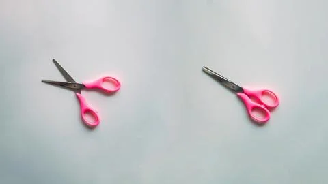 Pair of scissors with pink handle on white background, top view Stock Photos