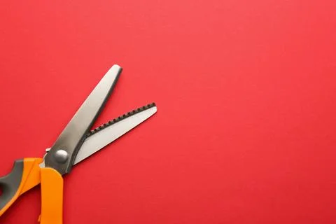 Pair of sharp scissors on color background, top view. Space for text Stock Photos