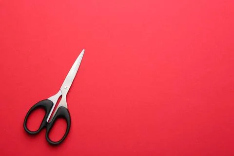 Pair of sharp scissors on color background, top view. Space for text Stock Photos