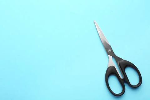 Pair of sharp scissors on color background, top view. Space for text Stock Photos
