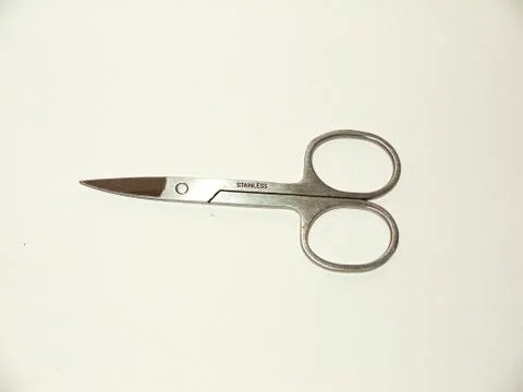 Pair of silver closed nail scissors sharp white background studio Stock Photos