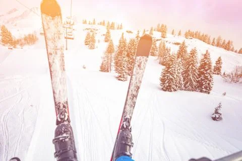 Pair of ski over snow covered forest from skilift Fotos Stock