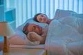 The pair sleeping together on the bed Photo