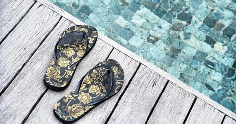 Pair of slip slops above a pool Stock Photos