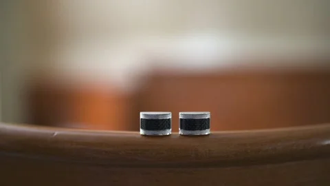Pair of Small Metal Cylinders on Curved Wooden Surface Stockbeeldmateriaal 336466942
