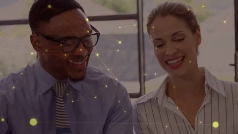 Pair smiling as camera panning to tablet, checking business docs, golden overlay Stock Footage 334466048