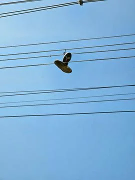 Pair of sneakers on light wiring Stock Photos