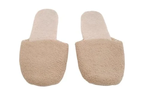 Pair of soft beige slippers on isolated white background. Comfortable fabri.. Stock Photos