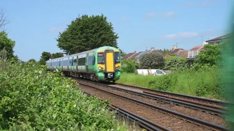 Pair of Southern Railway trains passing, UK. British railway travel. 4K Stock Footage 242517050