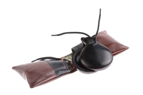 Pair of spanish castanets with leather pouches Stock Photos