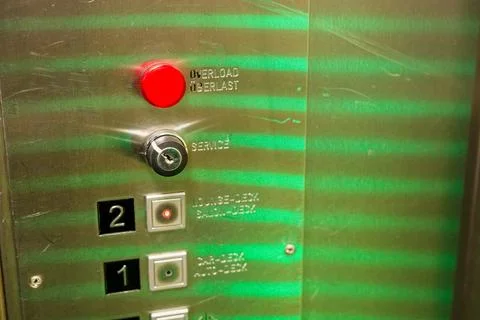 Pair of stainless steel elevators with lit floor buttons Stock Photos
