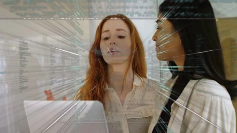 Pair starting laptop as code overlay streaming over them, pointing and nodding, Stock-Footage 335761726