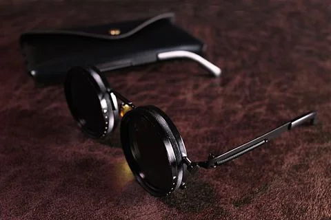 A pair of sunglasses on a table Stock Photos