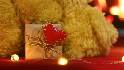 Pair of teddy bears are sitting hugging against the background of the fireplace Stock-Footage 168387665