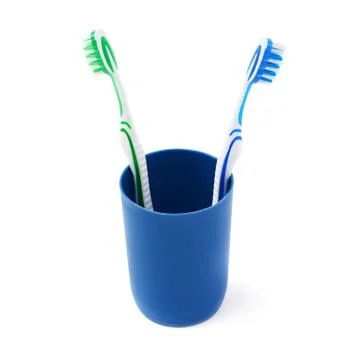 Pair of toothbrushes in blue plastic cup isolated over white background Fotos Stock