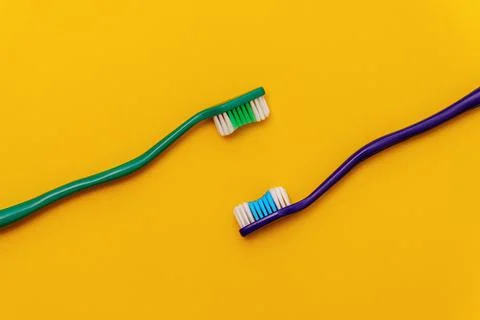 Pair of toothbrushes on orange flat lay Fotos de archivo