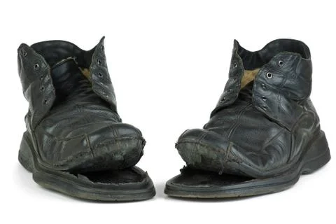 Pair of torn old boots Stock Photos
