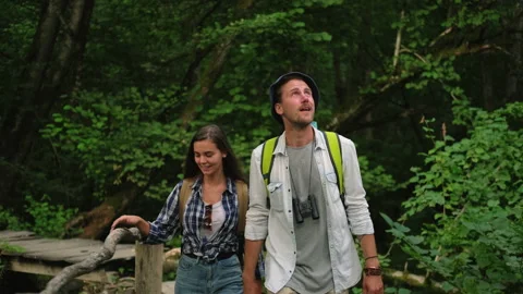 Pair of tourists are walking in forest, viewing natural landmarks Stock Footage 143960132