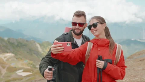 Pair of travellers taking picture at mount top, happy tired backpackers after Stock Footage 293080029