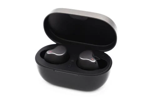 Pair of true wireless earbuds in case isolated on white background Fotos de archivo