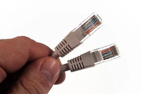 Pair of twisted Ethernet LAN network cables, in the hand of the master, Isola Foto stock