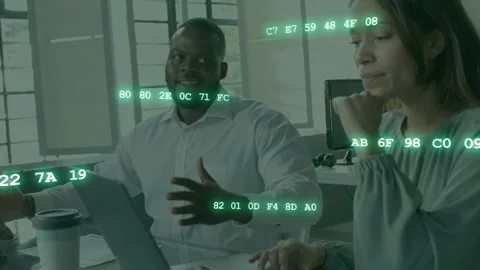 Pair typing on laptop, left man gesturing causing hex data overlay growing Stock Footage 333936659
