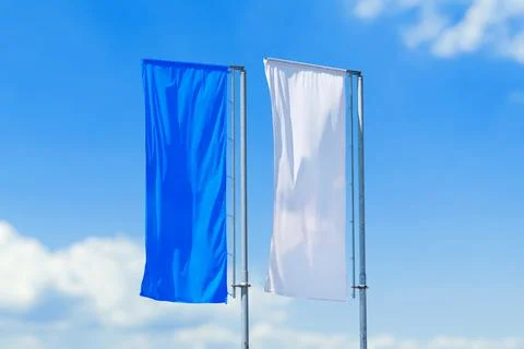 Pair of vertical flags in blue and white colors waving on poles Stock Photos
