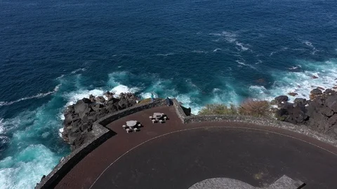 Pair at a viewpoint and blue boundless ocean. Rocky shore of Faial island Stock Footage 119600172