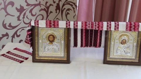 A pair of wedding icons are on the table. Wedding icons with images of saints Stock Footage 78267955