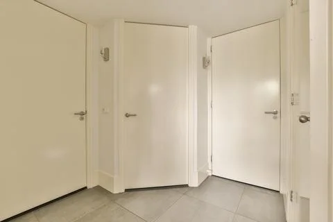 A pair of white doors in a room Stock Photos