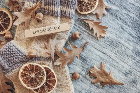 Pair of woolen socks and different dry decorations, wooden background Stock Photos
