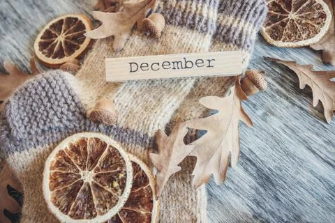 Pair of woolen socks and different dry decorations, wooden background Stock Photos